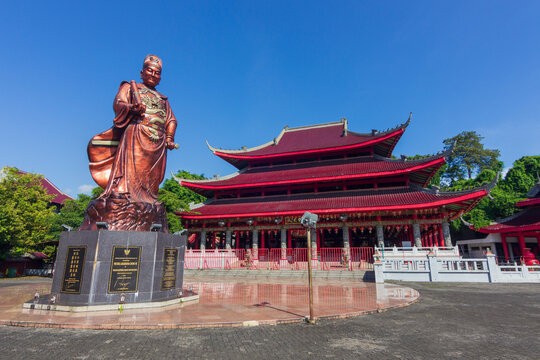 Semarang - Indonesia, May 6, 2025 : View of Sam Poo Kong temple complex, featuring a large bronze statue in the foreground. The statue of Admiral Zheng He