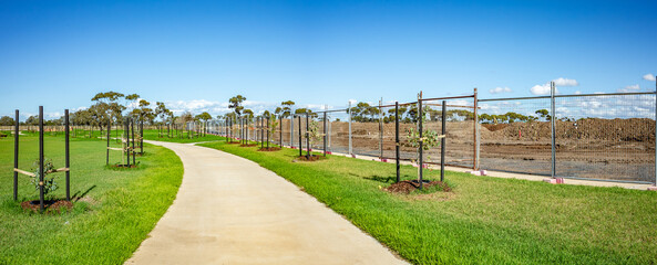 Newly developed walking path in Tarneit, outer suburb of Melbourne, Australia, bordered by young...