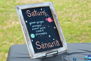 Chalkboard Sign for Saturn Sangria Drink with Fruit Ingredients
