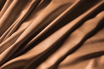 Brown fabric with folds as background, closeup