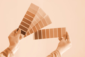 Female hands with violet paint palette swatches at home, closeup