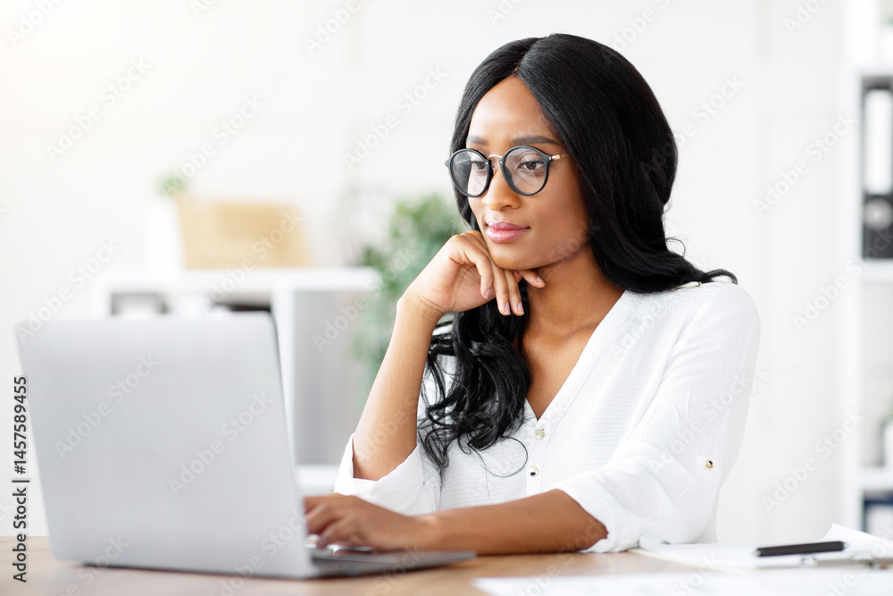 Poster positive female manager using laptop computer at workplace, typing document, taking part in online b