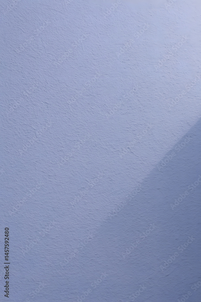 Aufkleber an abstract close-up of a subtle blue-grey textured surface with a diagonal shadow line