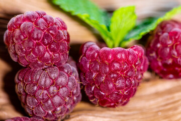 Macro photography of raspberry fruit on rustic wooden background