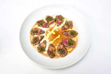 Tuna sashimi, sliced ​​tuna fillet with black sesame, olive oil and teriyaki sauce, food close up view	