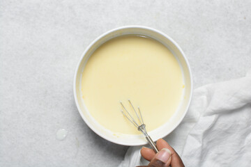 Overhead view of custard for making bread pudding, process of making bread pudding