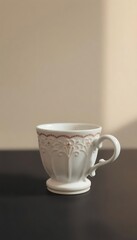 Fototapeta premium white cup sitting on top of a table