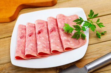 Sliced appetizing ham withe parsley closeup