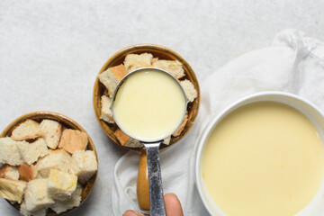 Overhead view of the process of making bread pudding