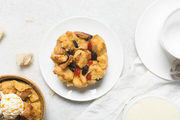 Overhead view of homemade bread pudding with raisins, top view of fresh bread pudding with raisins on a white background