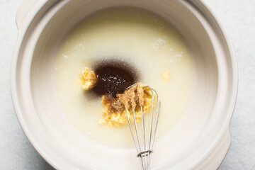 Overhead view of ingredients for making homemade pretzels dough being mixed in a bowl