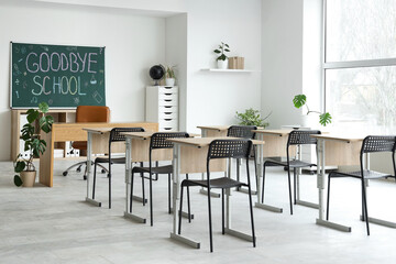 Interior of classroom with blackboard and desks. End of school year