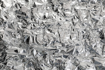 Crumpled aluminum foil as background, top view