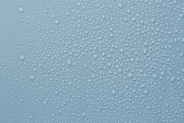 Many water drops on light blue background
