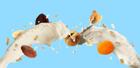 Milk splash with oat flakes and dried fruits on light blue background. Banner design