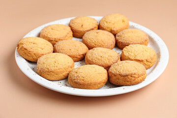 Plate with sweet cookies on brown background, closeup