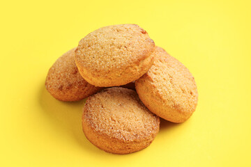 Many sweet cookies on yellow background, closeup