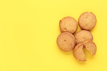 Many sweet cookies on yellow background