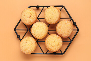 Stand with sweet cookies on brown background