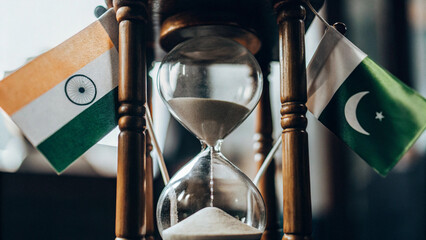 An hourglass where sand flows with Indian and Pakistani flags at opposite ends, symbolizing decades of tension, conflicts and war, AI