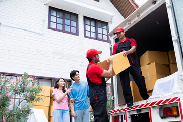 Asian couple newlywed looking to professional delivery logistic moving house worker lifting or...