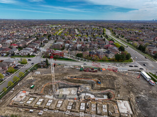 A new multi storey building rises in a Brampton Ontario suburban neighbourhood, highlighting the potential for tension between community growth and local resistance to development.