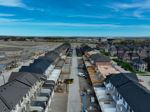 Aerial view of new housing development on the urban fringe of the north end of Brampton Ontario, bordering on Caledon, showing suburban sprawl construction of new homes.