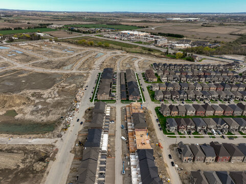 Aerial view of new housing development on the urban fringe of the north end of Brampton Ontario, bordering on Caledon, showing suburban sprawl construction of new homes.