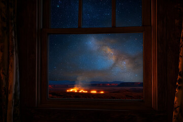 Fototapeta premium Nighttime view through a window of a landscape with fire and stars.