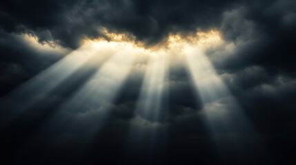 Fototapeta premium Dramatic sunbeams breaking through dark clouds hope power and heavenly light