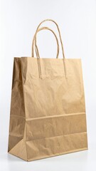 A crumpled brown paper bag rests on a clean white background, showcasing its textured surface and natural earthy tones, ideal for eco-friendly themes.