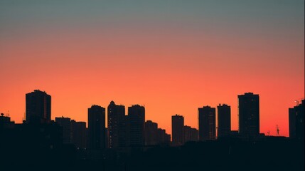 Obraz premium City skyline silhouette against a warm dusk sky, urban simplicity meets serene twilight. 
