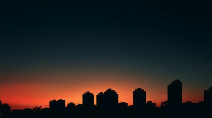 Fototapeta premium City skyline silhouette against a warm dusk sky, urban simplicity meets serene twilight. 