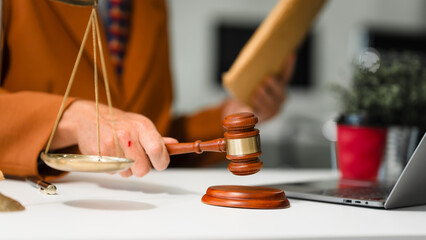 An elderly Caucasian male lawyer works at his desk in a law firm, offering legal advice and business law services. A gavel and documents symbolize justice and professionalism