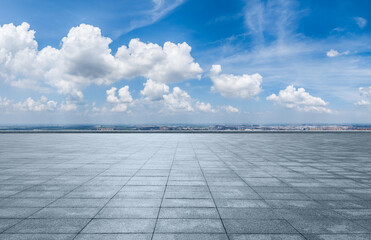 Empty square floor and city skyline with beautiful sky clouds on a sunny day