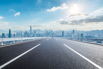 Straight asphalt road and city skyline with modern buildings in Shenzhen