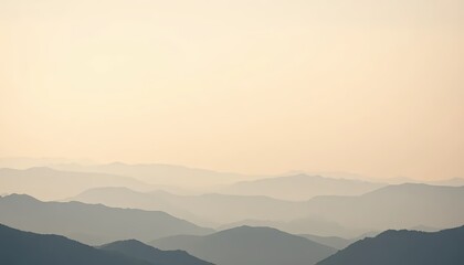 Obraz premium A serene, distant view of undulating mountain ranges under a soft