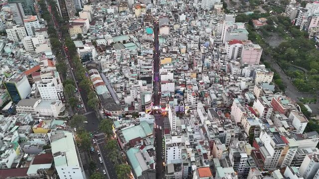 Aerial view of bui vien walking street and the entire city's skyline of Ho Chi Minh City, Vietnam. Drone footage of Saigon during late evening.