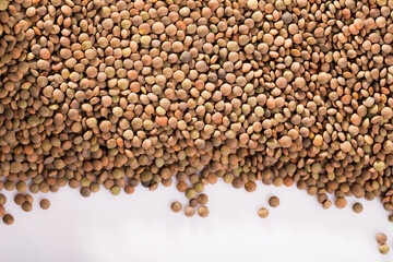 Closeup of raw lentil grains on white background. Concept of healthy and nutritious food