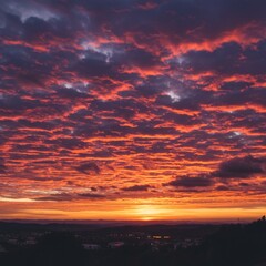 Obraz premium Vibrant Red And Orange Sunset Sky Over Cityscape
