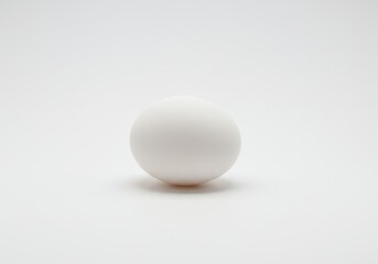 Single white ping pong ball on a white background, centered