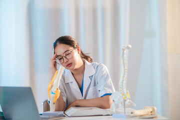  Asian Medical Student Studying Anatomical Model.