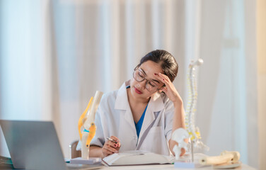  Asian Medical Student Studying Anatomical Model.
