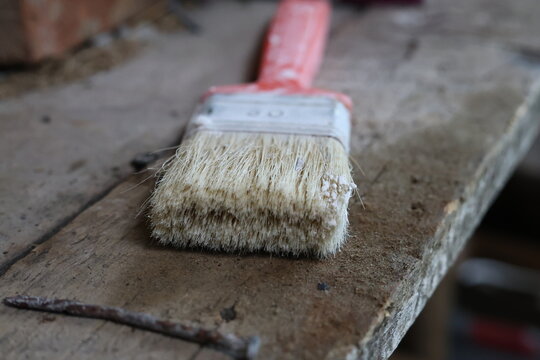 paint brush on wooden floor - Powered by Adobe