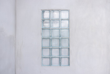 Fototapeta premium Building exterior under construction consist of concrete wall plastering and transparent glass block for light go inside building. Include empty coppy space for add text.