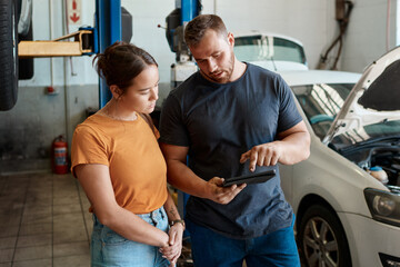 Customer, diagnostic and tablet with mechanic in garage for inspection, maintenance or vehicle...