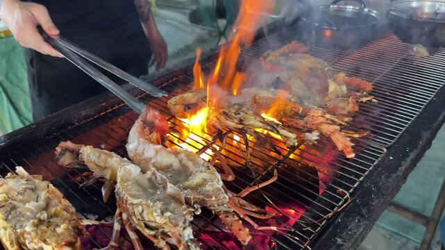 Lobsters grilling fire vibrant hues of grilled spiny lobsters contrast against the blackened grill. Their juicy meat caramelizes as the fire enhances the rich, smoky flavors of this seafood dish.