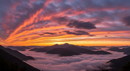 Misty mountain range with dramatic clouds at sunrise (horizontal).
