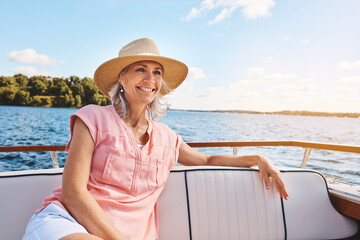 Blue sky, freedom and travel with mature woman on boat for sailing, adventure and summer vacation....