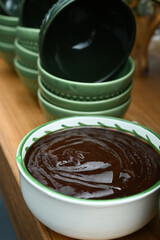 top view of a bowl with sauce on a black background, bowl with sauce, sauce, sauce on the table, a bowl with sauce, barbecue sauce


